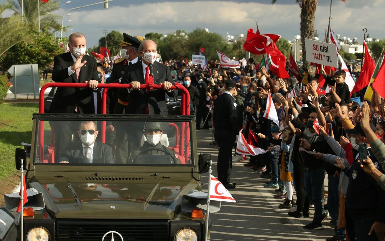 Turkish President Recep Tayyip Erdogan (L) and Turkish Republic of Northern Cyprus President Ersin Tatar (R) greet citizens during the ceremonies on November 15, 2020.  - Mustafa Kamaci/Anadolu Agency