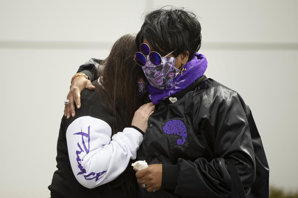 During the fifth anniversary observance of Prince's death, Patrice Files, of Detroit, right, consoles friend Virginia Ann Rausch, of Blaine, Minn., at Paisley Park, Wednesday, April 21, 2021, in Chanhassen, Minn. Fans of the legendary musician and artist were invited, 20 at a time, to pay their respects. (AP Photo/Stacy Bengs)