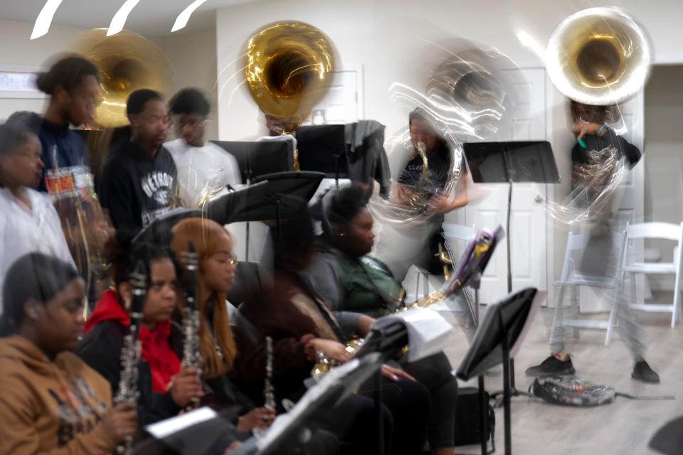 Tuba players bob up and down Tuesday night during the Wilberforce University Hounds of Sound marching band practice.