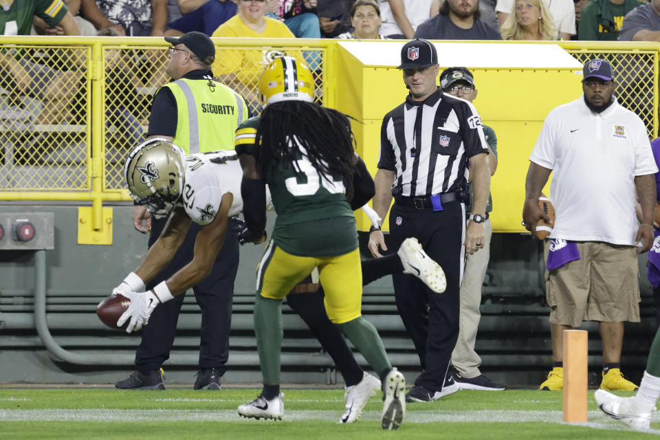 New Orleans Saints wide receiver Chris Olave (12) scores his first NFL touchdown reception during the first half of a preseason football game against the Green Bay Packers Friday, Aug. 19, 2022, in Green Bay, Wis. (AP Photo/Mike Roemer)