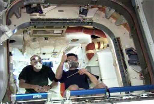 This frame grab from a NASA video shows NASA astronaut Don Pettit (L) and Russian cosmonaut and ISS Commander Oleg Kononenko enter the Dragon capsule on May 26. The ISS crew is to unhook the capsule from space station power sources on Thursday and complete final preparations