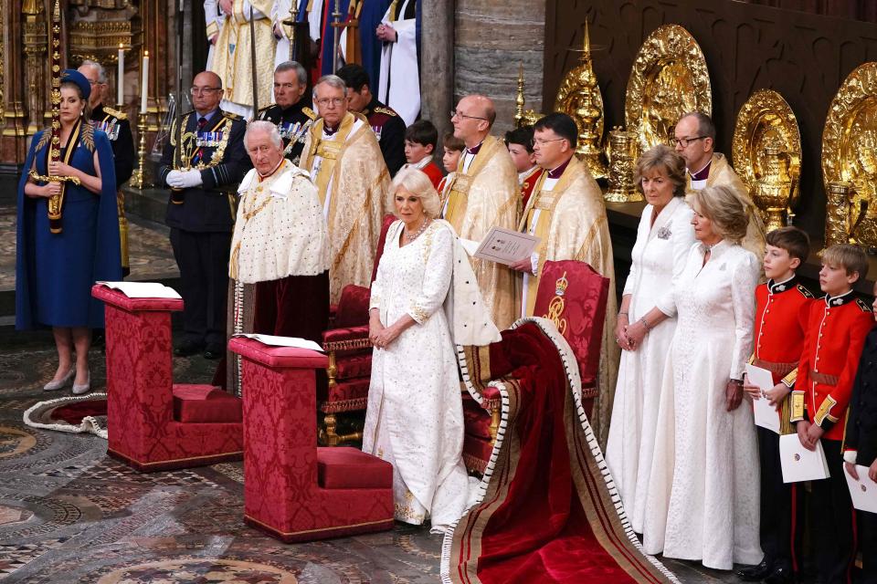 King Charles III and Camilla, Queen Consort stand after entering Westminster Abbey through the Great West Door (POOL/AFP via Getty Images)