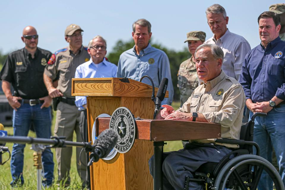 Texas Governor Greg Abbott, backed by other Republican state governors, military leaders, and law enforcement officers, speaks at a press conference on the United States' southern border in Mission, Texas on Oct. 6, 2021 to speak on what he described as the continuing crisis at the border.