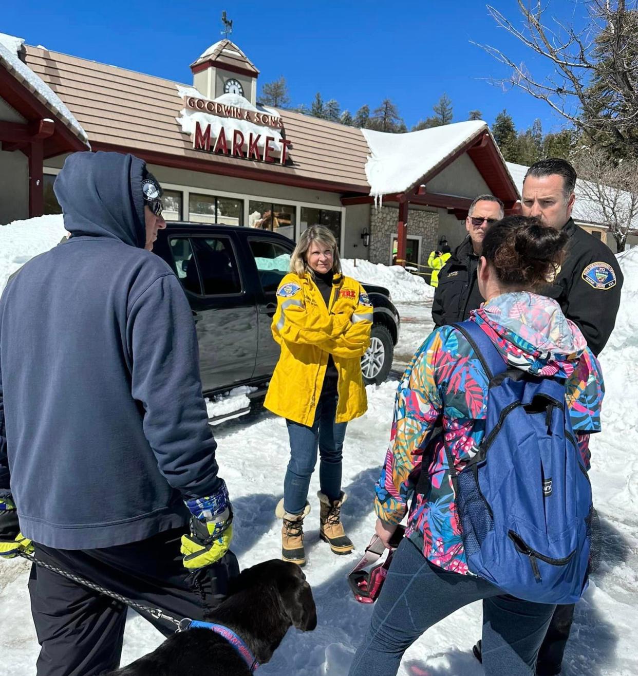 San Bernardino County Officials and Board of Supervisors Chair Dawn Rowe, center, whose third district oversees the mountain communities, surveyed the damage to Goodwin's Market in Crestline after the building’s roof collapsed.