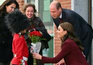 Henry Dynov-Teixeira, 8, of Somerville, presents flowers to Britain's Prince William and Kate, Princess of Wales, as his parents Melissa, left, and Irene, look on following a visit to Greentown Labs, Thursday, Dec. 1, 2022, in Somerville, Mass. (Angela Weiss Pool Photo via AP)