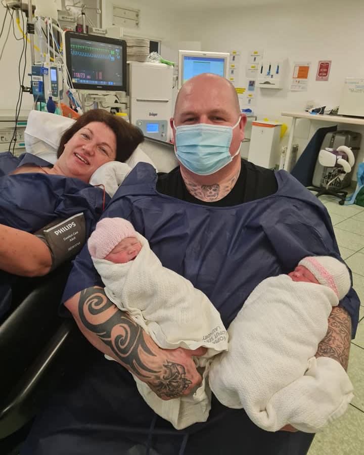 Danielle Martin and her partner Bryan Green holding their twin baby girls they didn't know they were having.