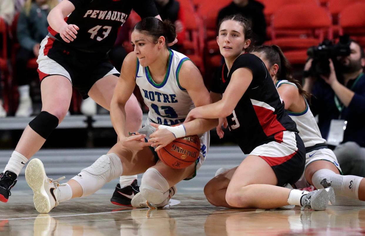 Green Bay Notre Dame's Kaia Waldrop (13) and Pewaukee's Giselle Janowski (23) fight for the ball during the WIAA Division 2 state championship Saturday at the Resch Center in Ashwaubenon.