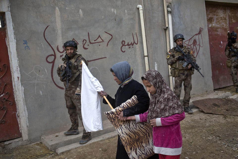 Civilians carry a white flag