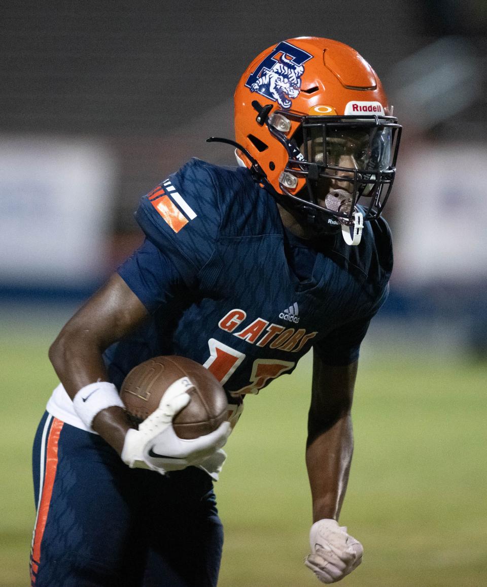 Diego Dukes (13) carries the ball during the Washington vs Escambia football game at Escambia High School in Pensacola on Friday, Sept. 29, 2023.