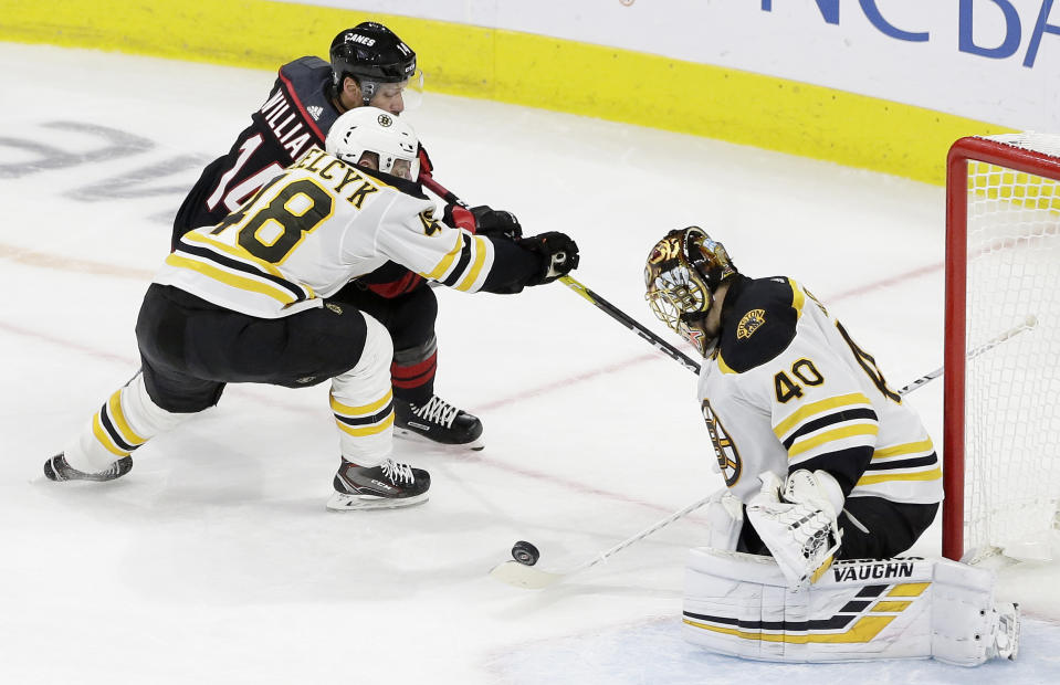 Boston Bruins' Matt Grzelcyk (48) and goalie Tuukka Rask, of Finland, defend against Carolina Hurricanes' Justin Williams (14) during the third period in Game 3 of the NHL hockey Stanley Cup Eastern Conference final series in Raleigh, N.C., Tuesday, May 14, 2019. Boston won 2-1. (AP Photo/Gerry Broome)