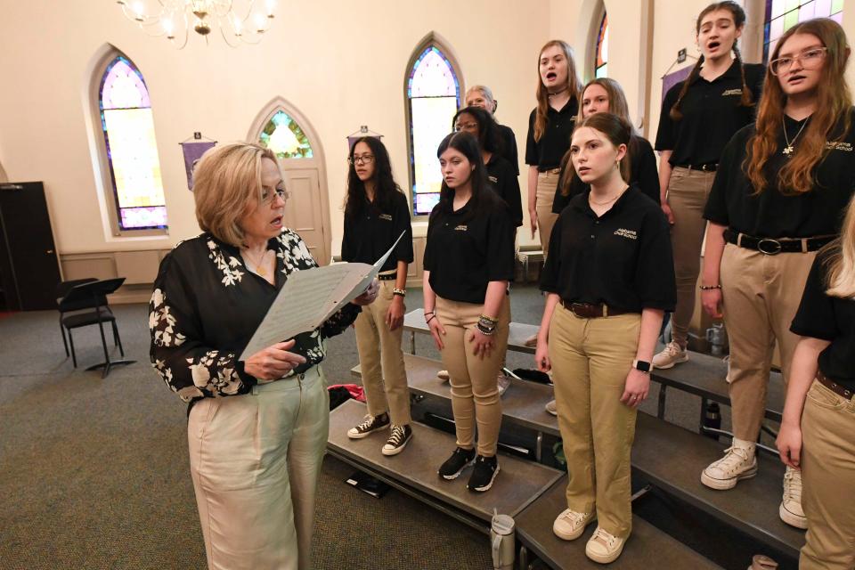April 17, 2024; Tuscaloosa, AL, USA; Doff Procter and his wife Laurel are retiring from directing the Alabama Choir School. Laurel Procter works with some of the girls to help them hit their notes correctly.