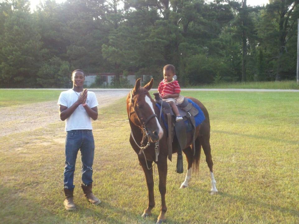 Ty Chandler, left, enjoys a moment in the Mississippi countryside years ago with his brother, Jonah, on horseback.