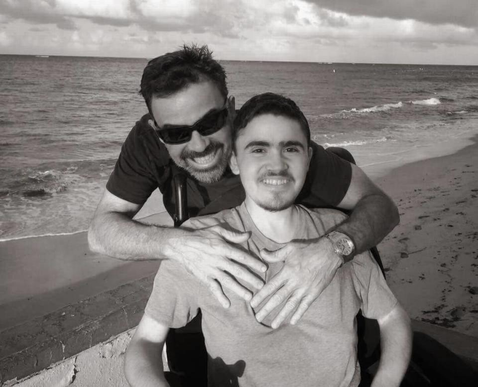 Luis Bermúdez, sitting, with his father, Luis Bermúdez. The youngest Bermúdez died in the collapse of the Champlain Towers South in Surfside on Thursday. 