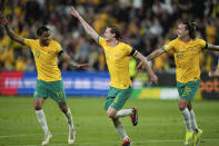Australia's Kye Rowles, centre, is congratulated by teammate's Jackson Irvine and Keanu Baccus, left, after scoring his team's second goal during the Soccer World Cup qualifying match between Lebanon and Australia in Sydney, Australia, Thursday, March 21, 2024. (AP Photo/Rick Rycroft)