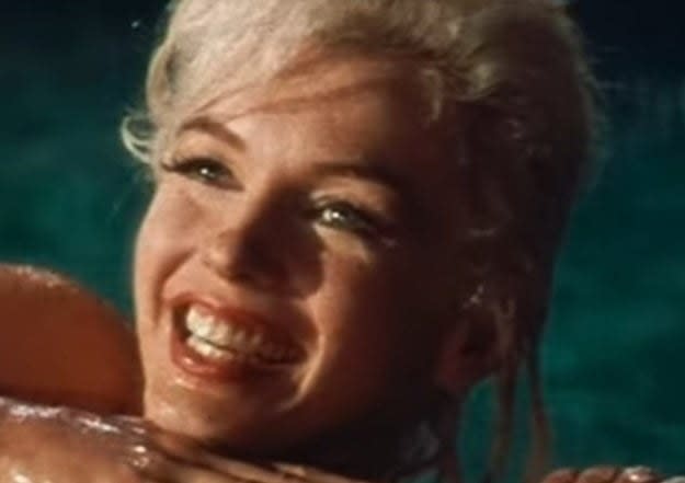 Marilyn smiles in a swimming pool while shooting "Something's Got to Give"