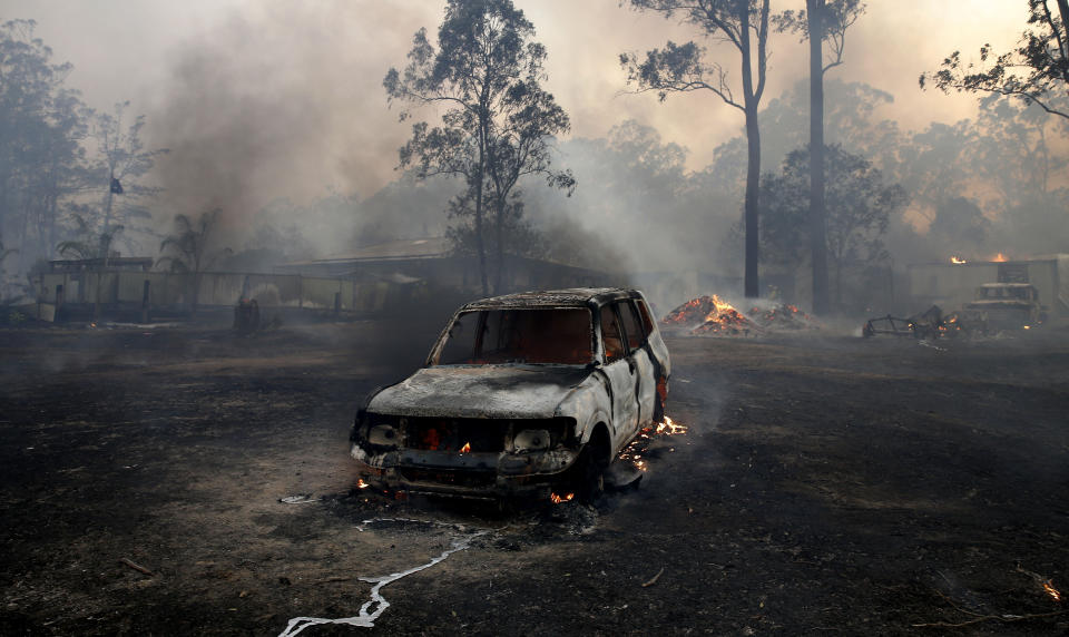 A burnt out car is seen at Possum Brush in the Mid North Coast region of NSW.