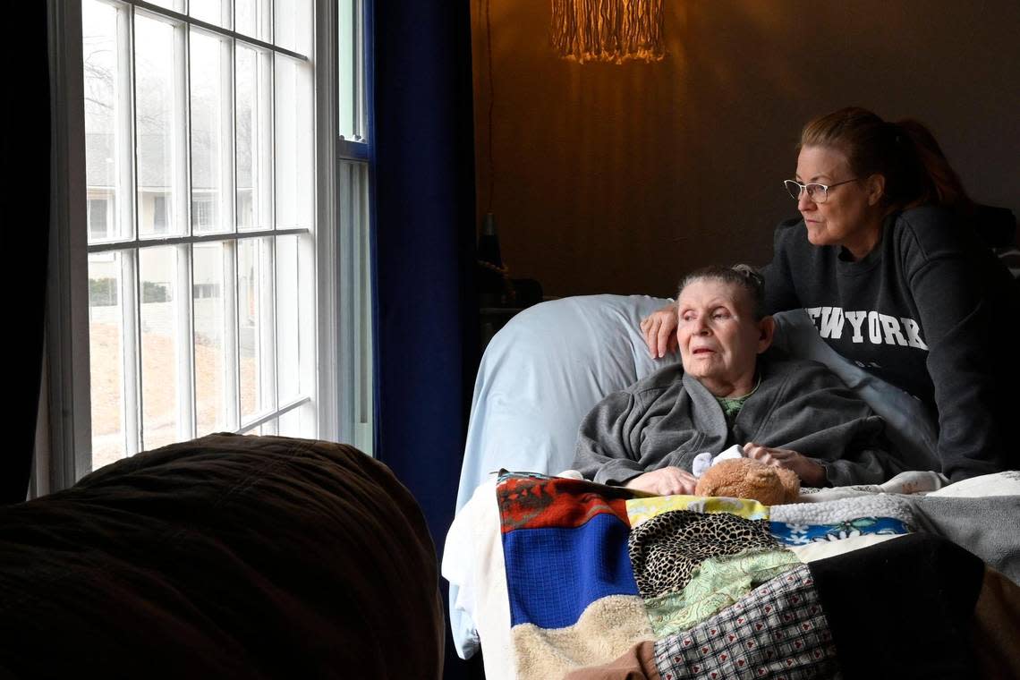 Ellen DeFoe, who is immobile and mostly non-verbal, enjoys looking out the big picture window from a recliner in Carol Dowell’s living room. Dowell is a full-time caregiver for DeFoe. 