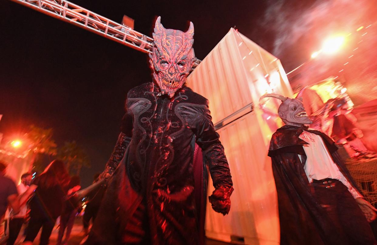 A costumed actor walks around the park scaring visitors on the opening night of the Halloween Horror Nights at Universal Studios Hollywood, in Universal City, Calif., September 9 , 2021. (Valerie Macon/AFP via Getty Images)