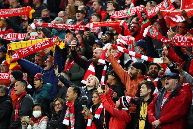 <p>Clive Brunskill/Getty Images</p> Liverpool soccer supporters before a match between Liverpool and Manchester United.