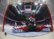 Canada's Jeff Carter (R) scores his second goal on Austria's goalie Bernhard Starkbaum during the second period of their men's preliminary round ice hockey game at the 2014 Sochi Winter Olympic Games, February 14, 2014. REUTERS/Mark Blinch/Pool (RUSSIA - Tags: TPX IMAGES OF THE DAY OLYMPICS SPORT ICE HOCKEY)