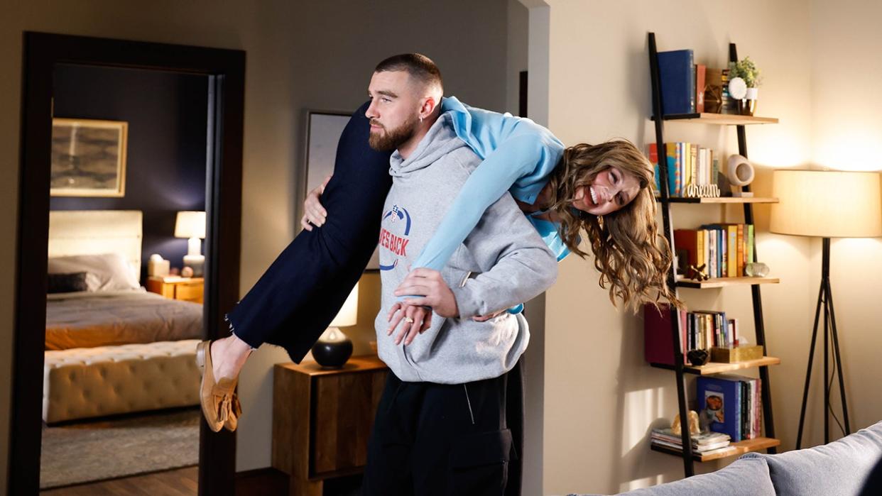 Travis Kelce carrying Heidi Gardner over his shoulder in an SNL sketch