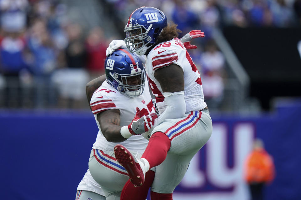 New York Giants' Leonard Williams, right, and Dexter Lawrence celebrate a sack during the first half of an NFL football game against the New York Giants, Sunday, Oct. 17, 2021, in East Rutherford, N.J. (AP Photo/Frank Franklin II)