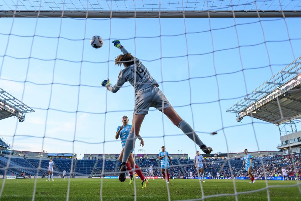 Chicago Red Stars goalkeeper Mackenzie Wood jumps to make a save during a game against Racing Louisville FC at SeatGeek Stadium on May 25, 2024.