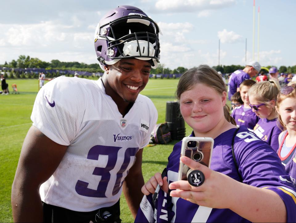 Minnesota Vikings fullback C.J. Ham takes a selfie with a fan at the end of NFL football practice in Eagan, Minn., Monday, July 30, 2018. (AP Photo/Andy Clayton-King)