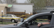 A Colorado Springs Police Department officer is stationed at the end of the street where multiple people were shot and killed early Sunday, May 9, 2021, in Colorado Springs, Colo. The suspected shooter was the boyfriend of a female victim at the party attended by friends, family and children. He walked inside and opened fire before shooting himself, police said. Children at the attack weren’t hurt and were placed with relatives. (Jerilee Bennett/The Gazette via AP)