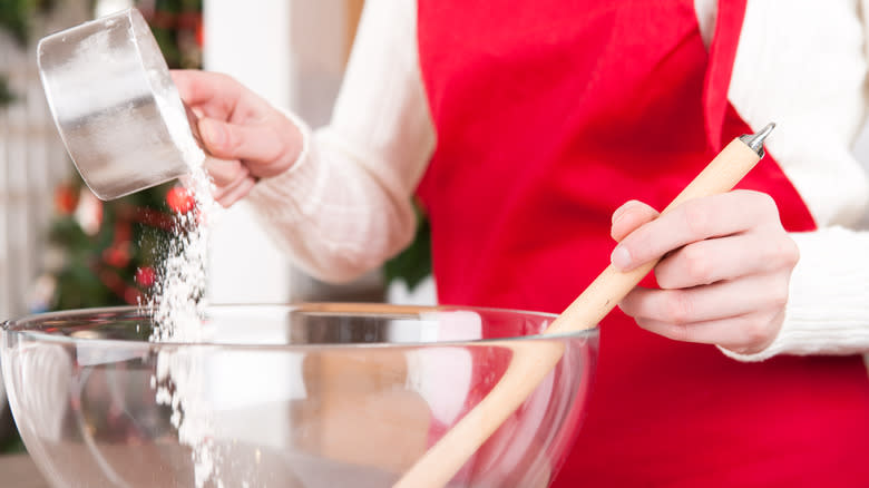 Person pouring flour into bowl