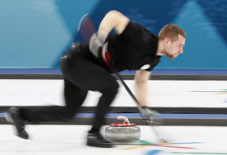 Curling – Pyeongchang 2018 Winter Olympics – Mixed Doubles Semi-final - Olympic Athletes from Russia v Switzerland - Gangneung Curling Center - Gangneung, South Korea – February 12, 2018 - Olympic Athlete from Russia Aleksandr Krushelnitckii sweeps. REUTERS/Cathal McNaughton