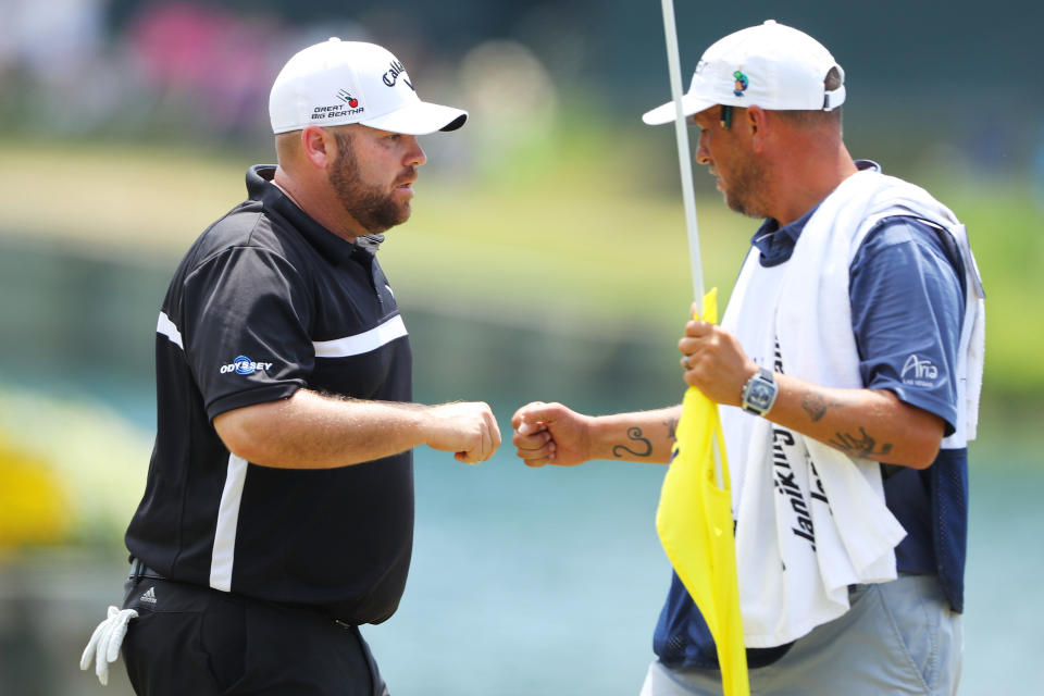 Knost fist pumps his caddie during The Players Championship