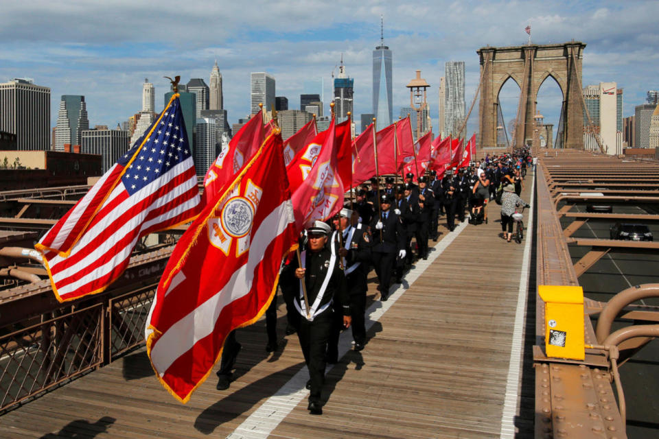 Members of Engine 219 Ladder 105 and fellow firefighters march to Brooklyn over the Brooklyn Bridge in honor of firefighters lost in the 9/11 attacks