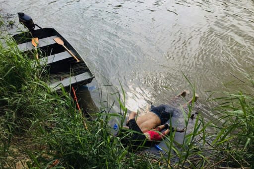 The bodies of a Salvadoran man and his small daughter lie at the edge of the Rio Grande, in which they drowned trying to cross into the US on June 24