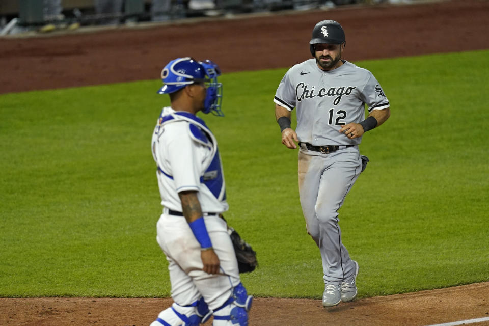 Chicago White Sox's Adam Eaton (12) runs home to score on a double by Jose Abreu during the sixth inning of the team's baseball game against the Kansas City Royals on Friday, May 7, 2021, in Kansas City, Mo. (AP Photo/Charlie Riedel)