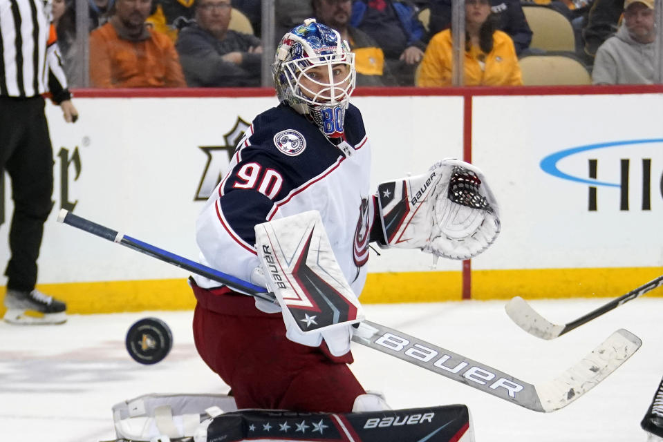 FILE - Columbus Blue Jackets goaltender Elvis Merzlikins blocks a shot during the second period of the team's NHL hockey game against the Pittsburgh Penguins in Pittsburgh, April 29, 2022. Merzlikins is the presumed starter at goaltender. He started 59 games last year after signing a five-year contract extension. (AP Photo/Gene J. Puskar, File)