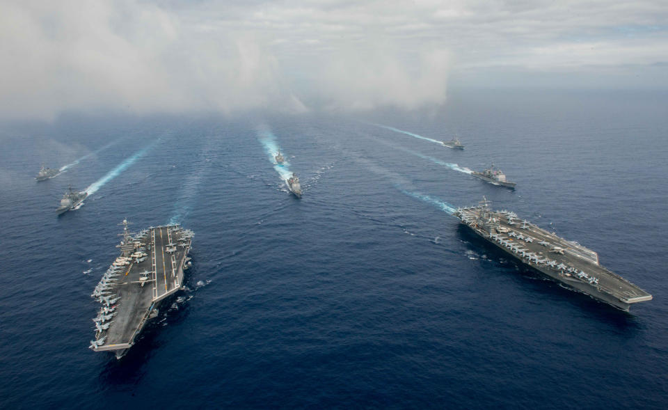 In this handout provided by the U.S. Navy, The Nimitz-class aircraft carriers USS John C. Stennis (CVN 74) (L) and USS Ronald Reagan (CVN 76) conduct dual aircraft carrier strike group operations in the U.S. 7th Fleet area of operations in support of security and stability in the Indo-Asia-Pacific. (Photo by Specialist 3rd Class Jake Greenberg/U.S. Navy via Getty Images)