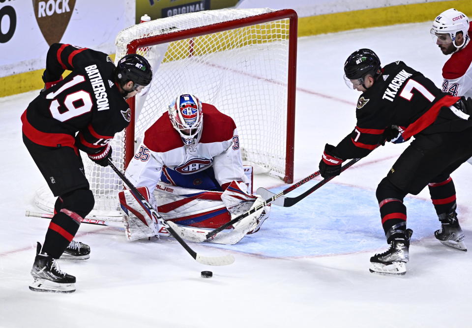 Ottawa Senators right wing Drake Batherson (19) and left wing Brady Tkachuk (7) try to get a shot on Montreal Canadiens goaltender Sam Montembeault (35) during the third period of an NHL hockey game in Ottawa, on Wednesday, Dec. 14, 2022. (Justin Tang/The Canadian Press via AP)