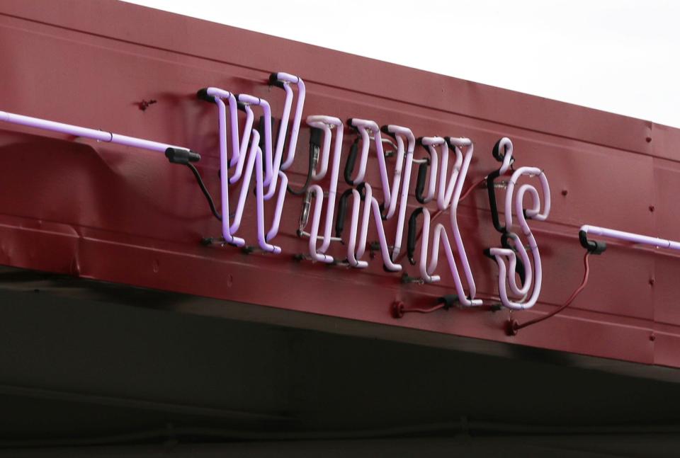 An original neon sign on the carhop roof at Wink's.