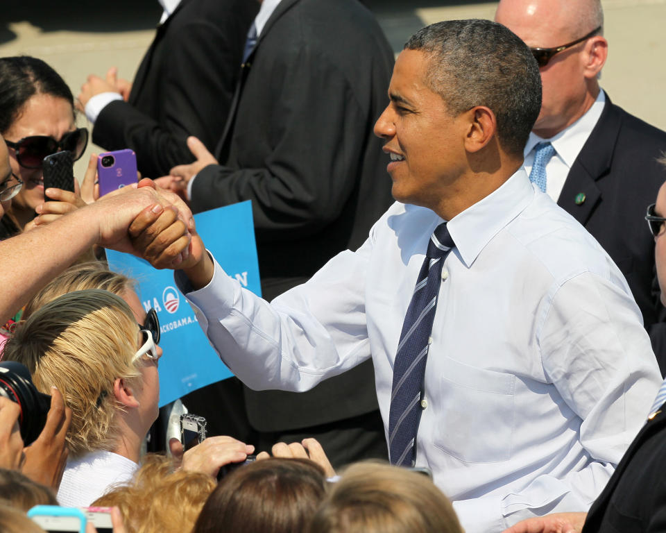 President Barack Obama greets visitors, Tuesday, Aug. 28, 2012, at the Des Moines International Airport in Des Moines, Iowa. (AP Photo/Chris Donahue)