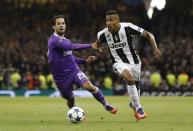<p>Juventus’ Alex Sandro in action with Real Madrid’s Isco </p>