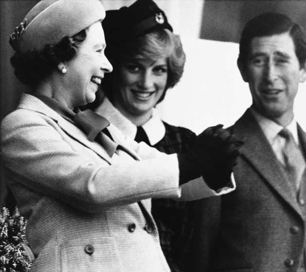 Queen Elizabeth laughs after her hands became stuck together after shaking hands with the winner of the caber toss, who warned the queen of the resin in his hands, at the Braemar Highland Games. Prince Charles and Princess Diana, who married Charles in 1981, stand with the queen.