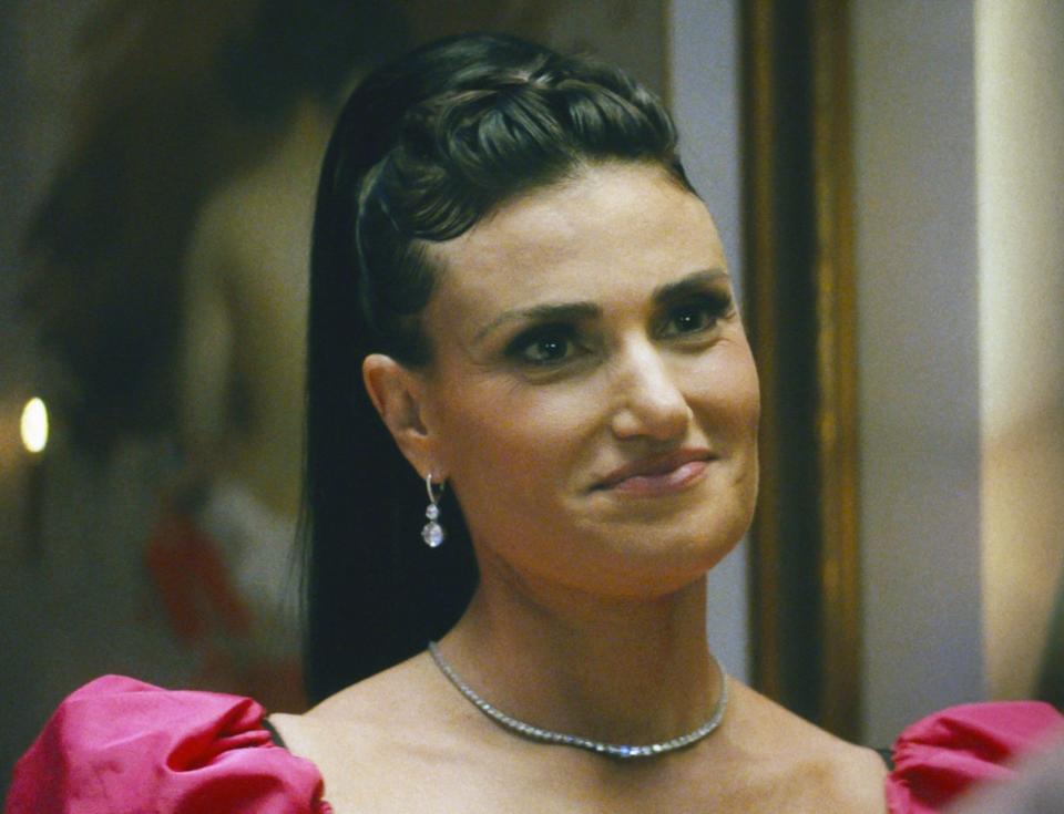 Idina Menzel wears a formal gown with puffed sleeves