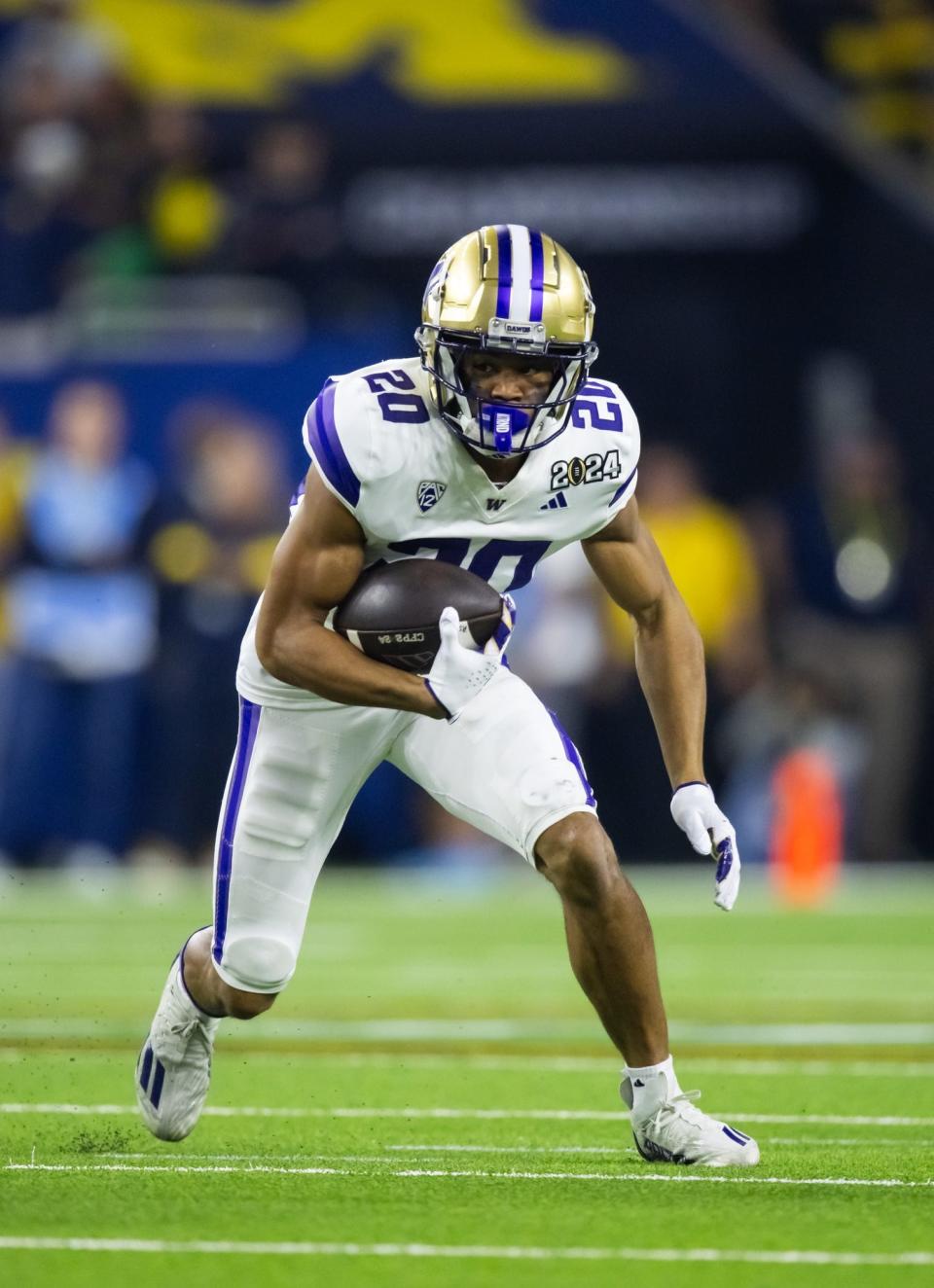 Washington Huskies running back Tybo Rogers carries the ball against Michigan during the 2024 College Football Playoff national championship game in Houston.