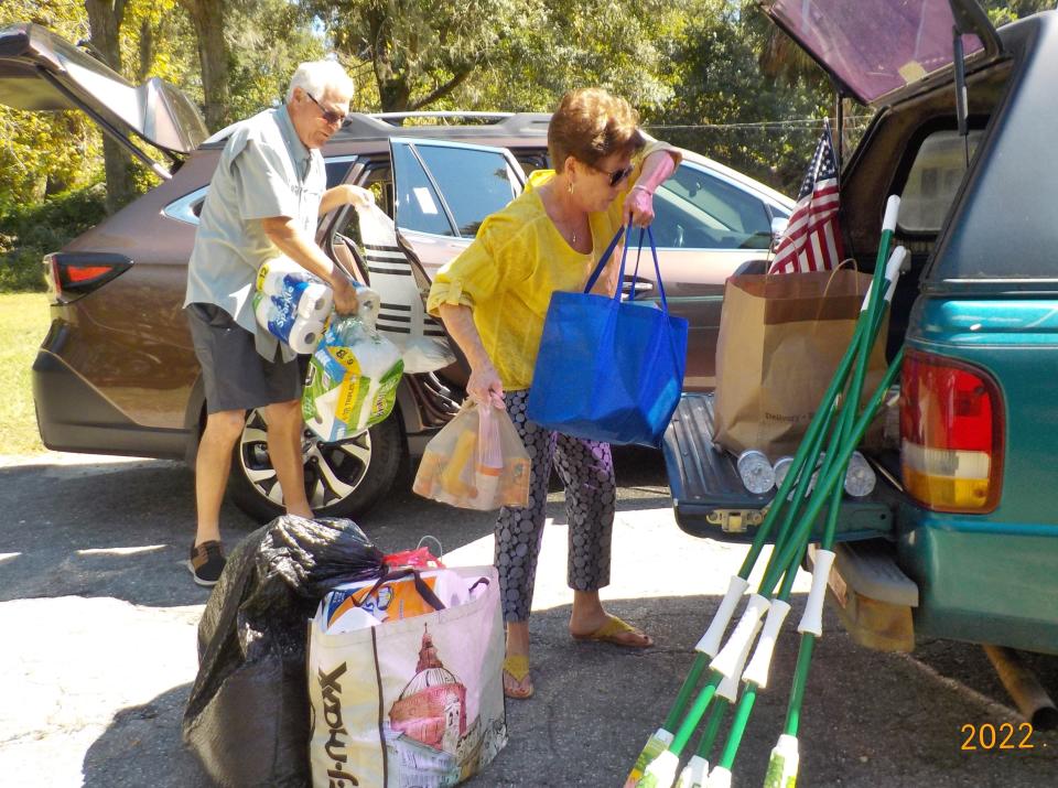 Volunteers load donations for delivery to Hurricane Ian survivors in the Fort Myers area.