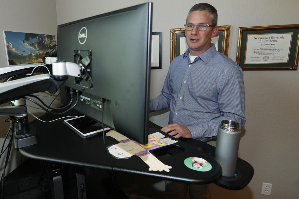 In this Monday, July 1, 2019, photo, software engineer Joe Wilson works in his home in Highlands Ranch, Colo. The tariffs that the Trump administration has placed on thousands of products imported from China and retaliatory duties placed on U.S. goods are affecting many small businesses, even if they’re not importers or exporters. Wilson might have to put off hiring freelancers if he feels the ripple effects of tariffs that his customers must pay. (AP Photo/David Zalubowski)