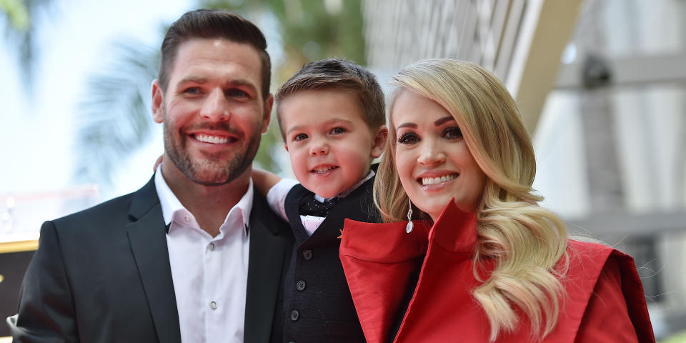 Image: Carrie Underwood poses with her husband Mike Fisher and their son Isaiah