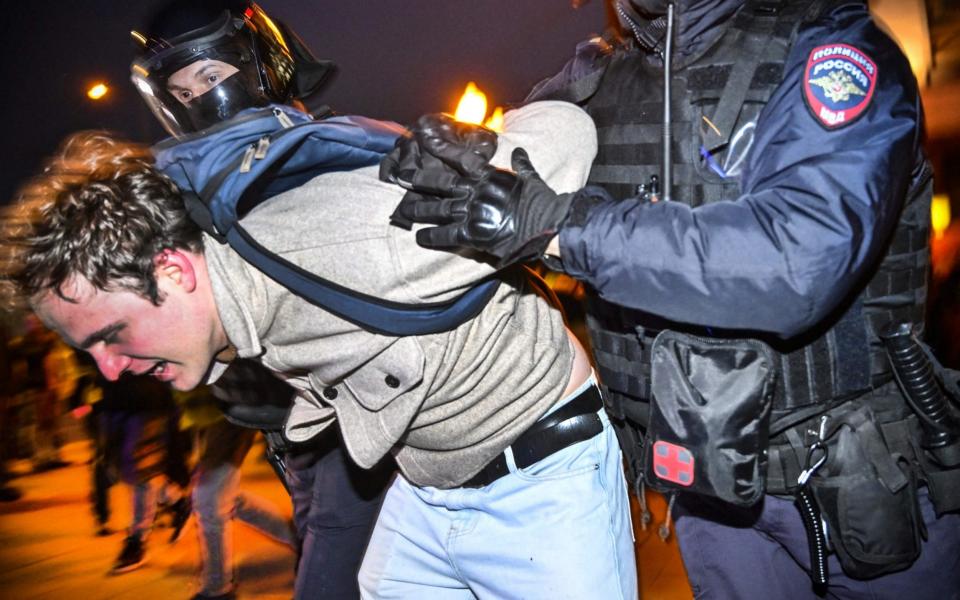 Police in Moscow detain a man for protesting against the partial mobilisation announced by Vladimir Putin. - ALEXANDER NEMENOV/AFP