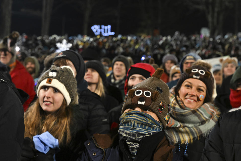 Spectators watch the festivities while waiting for Punxsutawney Phil, the weather prognosticating groundhog, to come out and make his prediction during the the 137th celebration of Groundhog Day on Gobbler's Knob in Punxsutawney, Pa., Thursday, Feb. 2, 2023. (AP Photo/Barry Reeger)