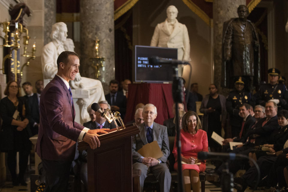 House Speaker Nancy Pelosi and Senate Majority Leader Mitch McConnell of Ky., watch and listen to Saints quarterback Drew Brees, speak during a Congressional Gold Medal ceremony honoring amyotrophic lateral sclerosis (ALS) advocate and former National Football League (NFL) player, Steve Gleason, in Statuary Hall on Capitol Hill, Wednesday, Jan. 15, 2020, in Washington. (AP Photo/Manuel Balce Ceneta)